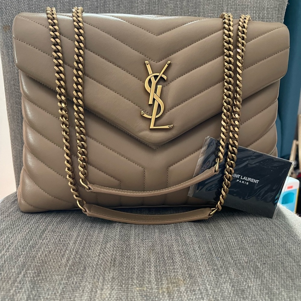 Worn once, plastic on zipper. comes with dust bag